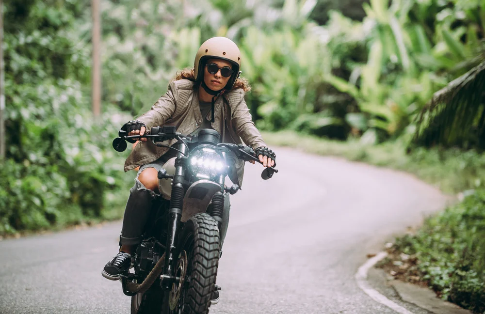 woman riding motorcycle on road