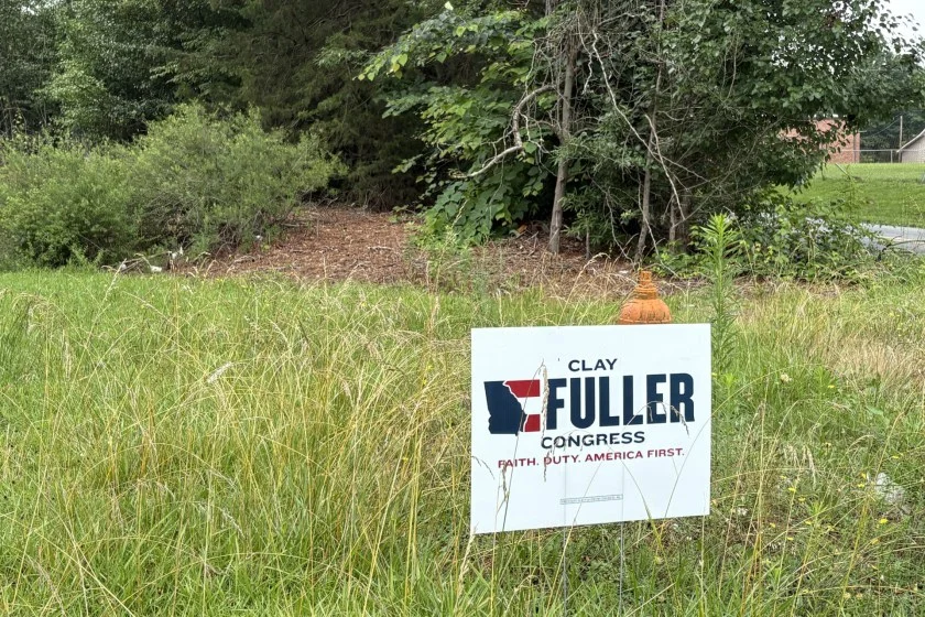 A political campaign poster that reads Fuller in a yard